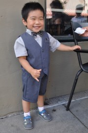 Wesley wearing a black and silver bow tie and a matching striped vest and pants.